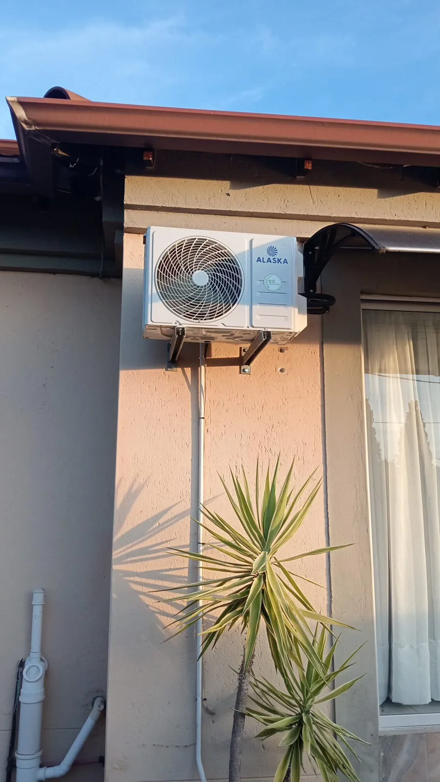 Alaska outdoor unit fitted on a bracket outside a Newcastle home