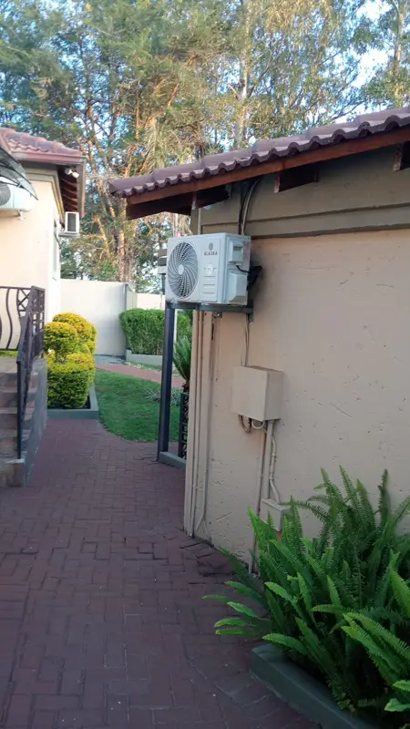 Alaska aircon outdoor unit installed on a wall bracket
