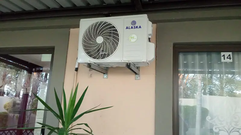 Alaska aircon outdoor unit installed on a wall bracket